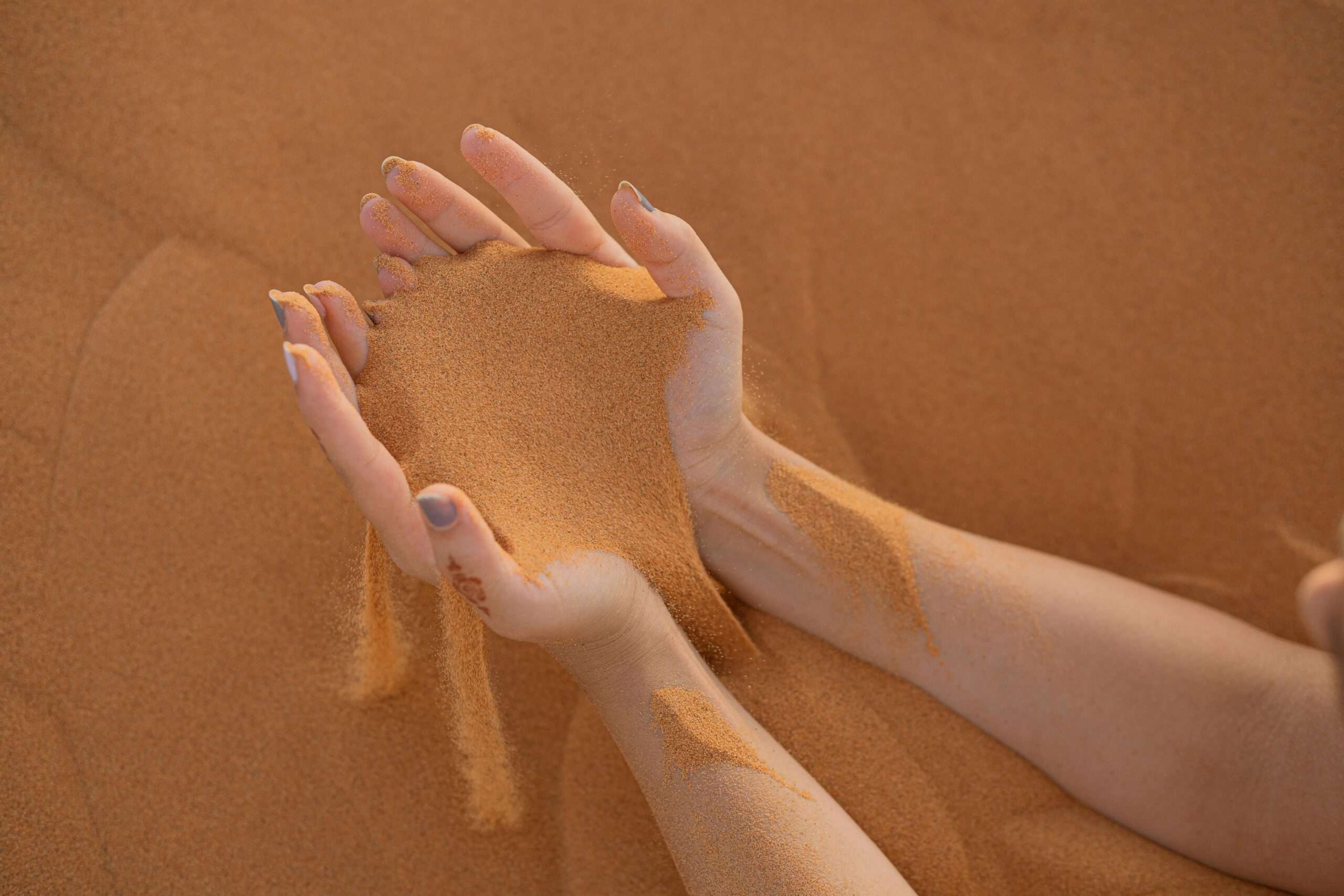 Sand on a Person's Hands